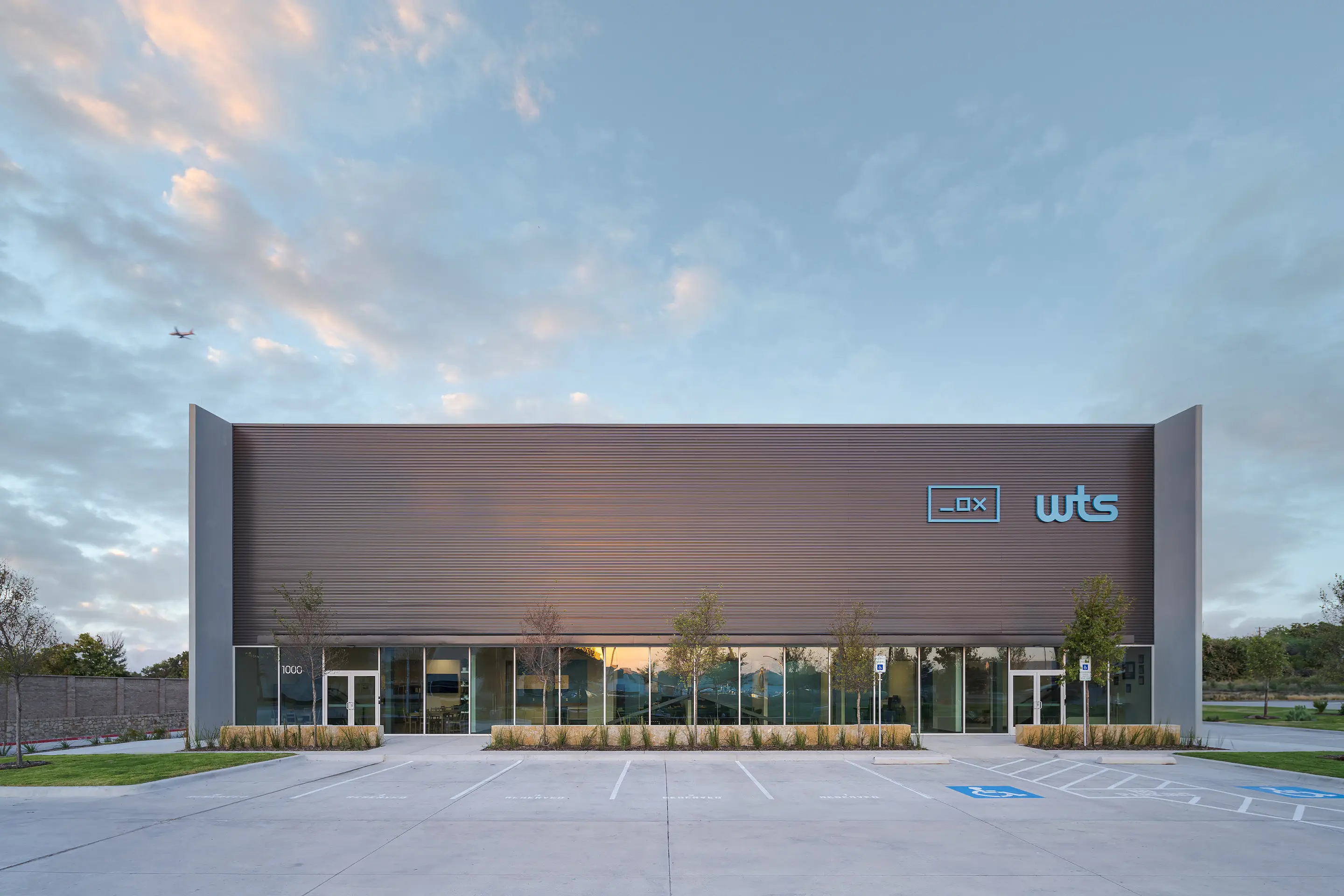 The WesternTechSystems facility facade at blue hour