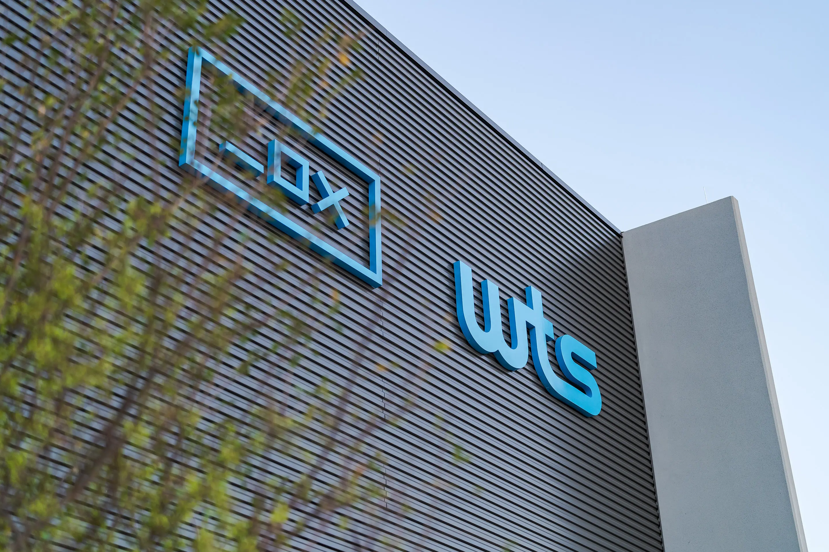 The illuminated WesternTechSystems signage on the facility's corrugated metal facade