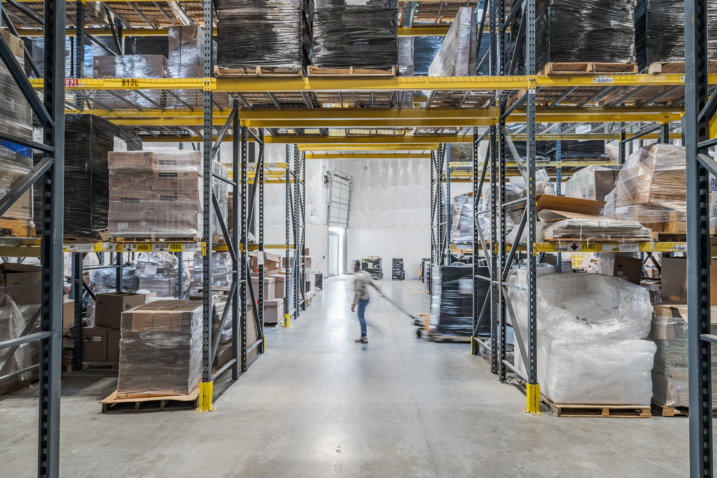 Graded network and enterprise hardware held in high-bay racking at the WesternTechSystems facility